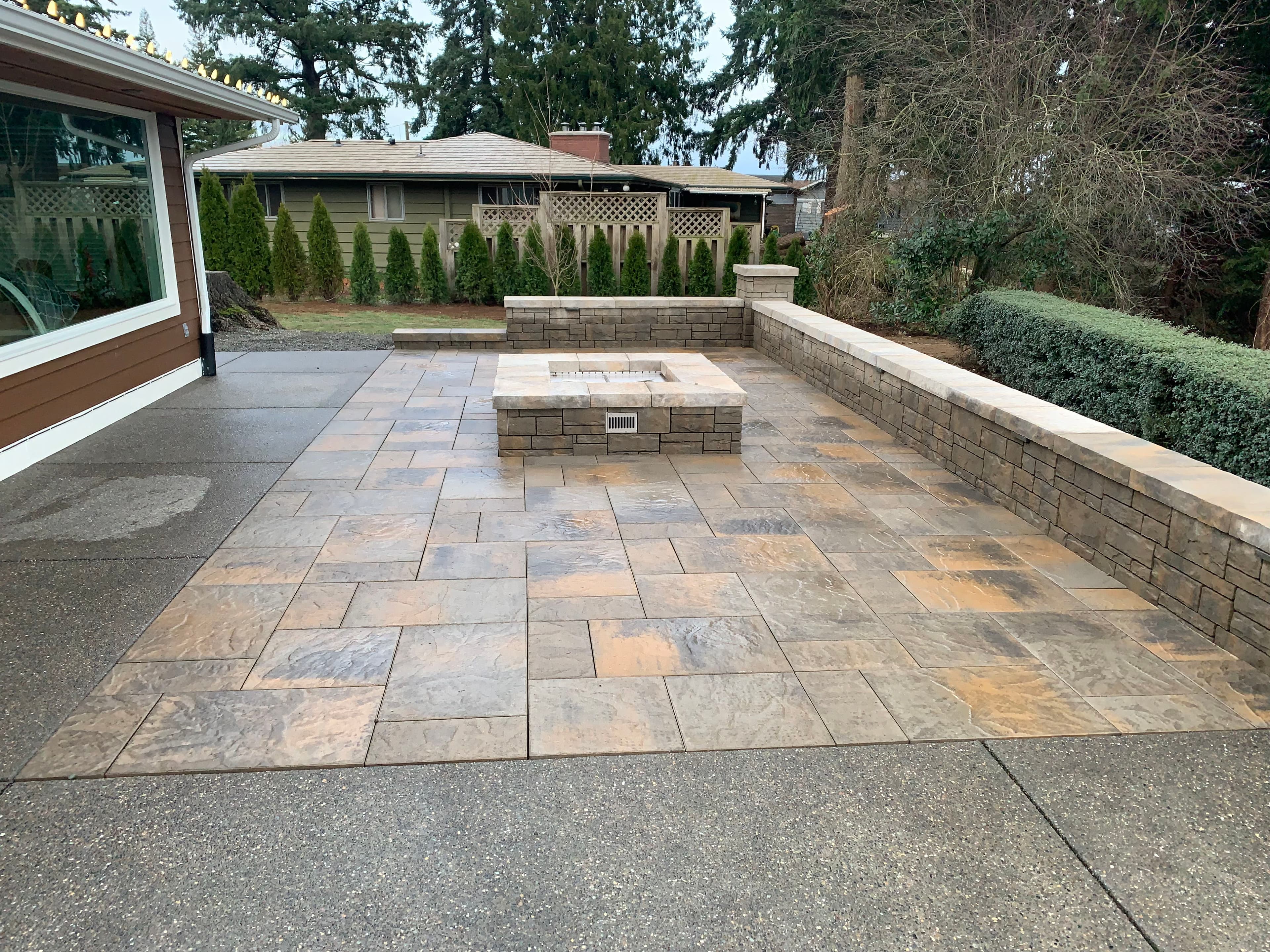 Elegantly Crafted Patio with Fire Pit and Stone Retaining Wall