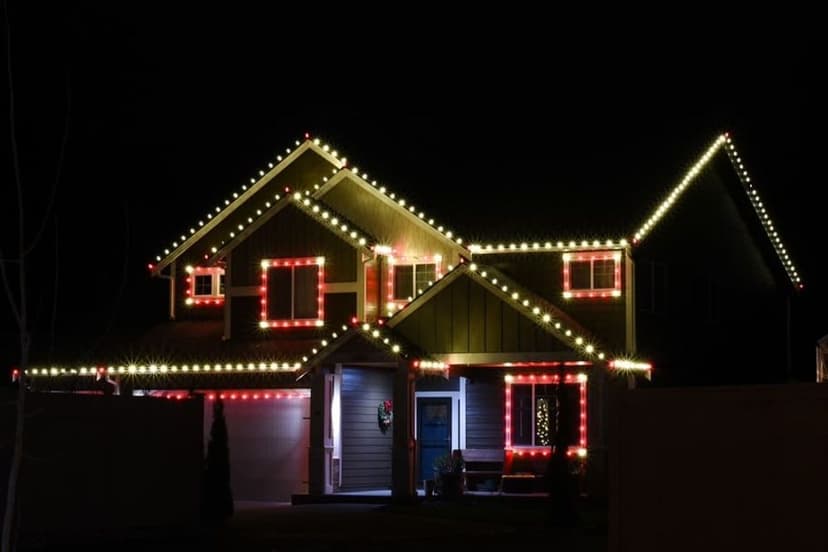 Festively decorated house with colorful Christmas lights shining at night.